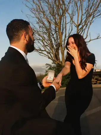 A woman reacts with surprise to the marriage proposal.