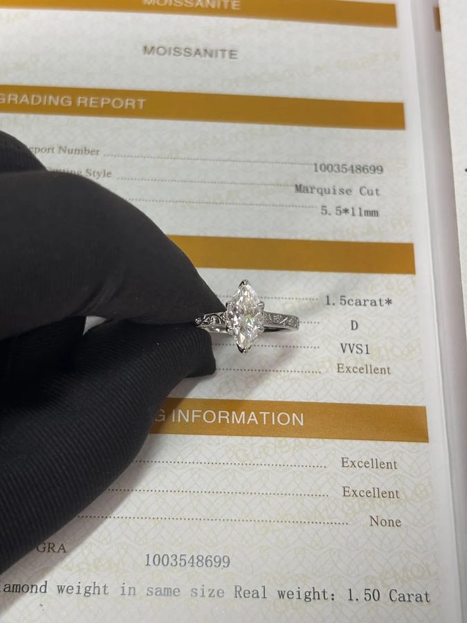 Custom-made marquise engagement ring with an engraved band by Velur