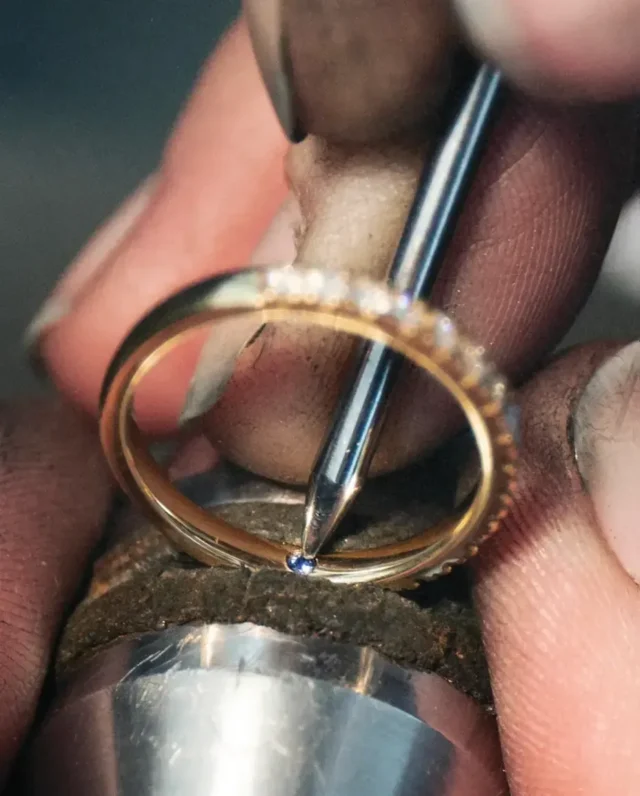 Velur Goldschmied sets stones into a ring by hand